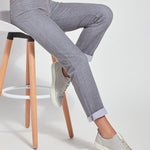 color=Uptown Grey, Seated view of uptown gray, 4-way stretch, relaxed boyfriend denim jean legging with interior waistband