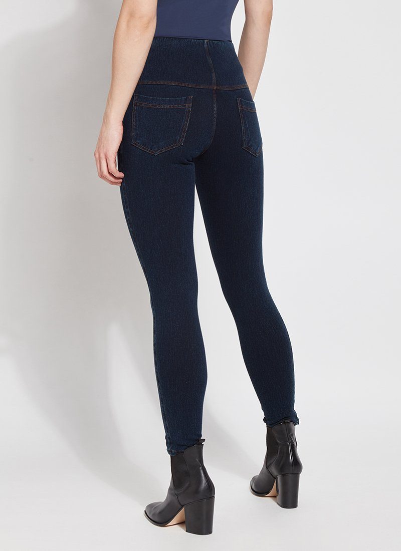 color=Indigo, Angled read view of indigo, toothpick denim jean leggings with patented concealed waistband, seen from waist down