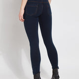 color=Indigo, Angled read view of indigo, toothpick denim jean leggings with patented concealed waistband, seen from waist down