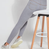 color=Uptown Grey, Seated rear view of uptown gray toothpick denim jean leggings with patented concealed waistband