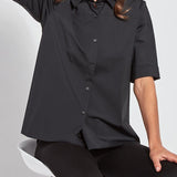 color=Black, seated front view, slim fit women’s short sleeve button up shirt in wrinkle resistant microfiber