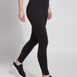 color=Black, Angled side view black denim skinny jean legging with concealing waistband