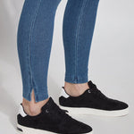 color=Mid Wash, detail view of denim skinny jean legging with concealing waistband, seen from knee down