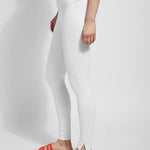 color=White, Side view white denim skinny jean legging with concealing waistband, seen from waist down