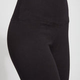 color=Black, Angled detailed shot of front right hip, black cotton and spandex leggings with concealed slimming signature waistband