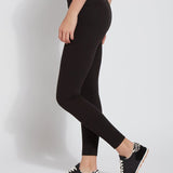 color=Black, Side view of black cotton and spandex leggings with concealed slimming signature waistband, from waist down