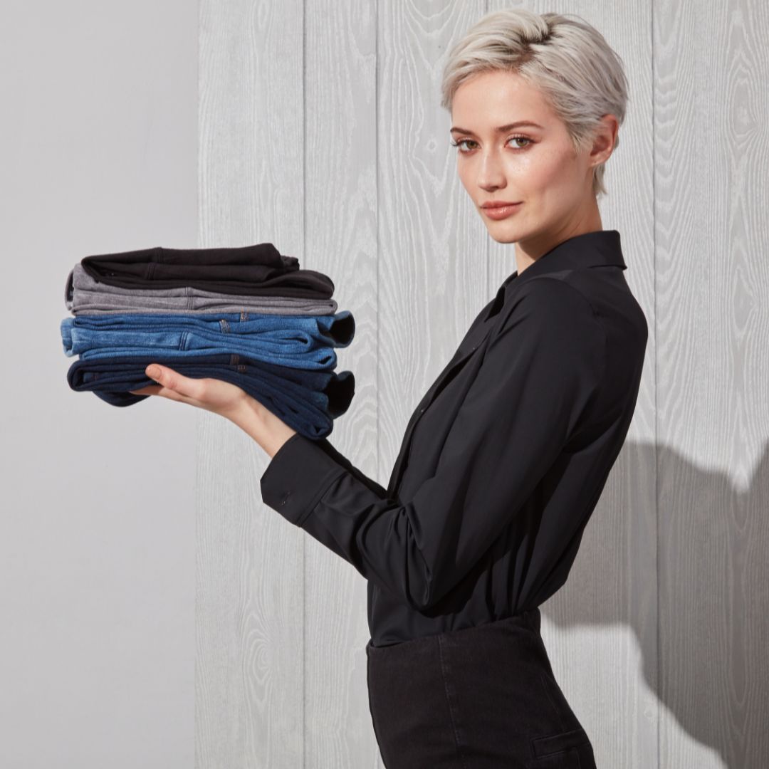 Woman holding denim and leggings