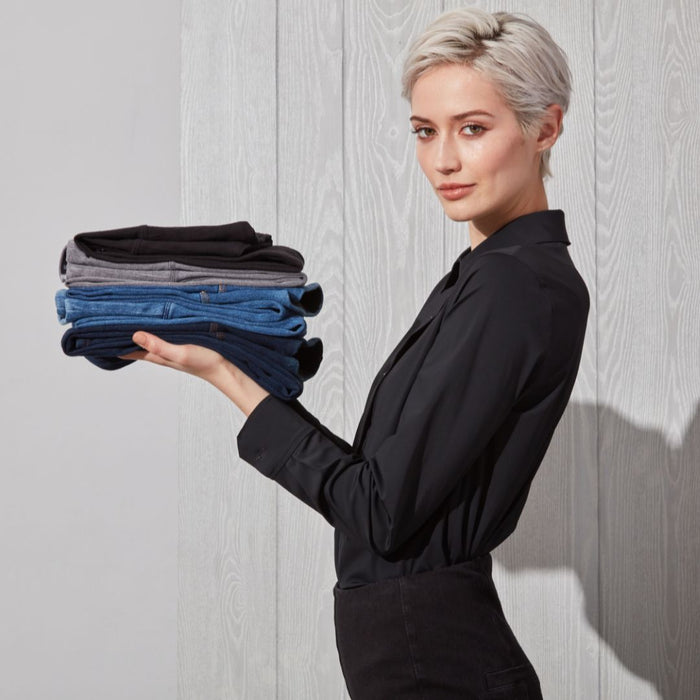Woman holding denim and leggings
