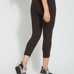 color=Black, back view, cropped denim jean leggings with zipper detail at hem and comfort waistband