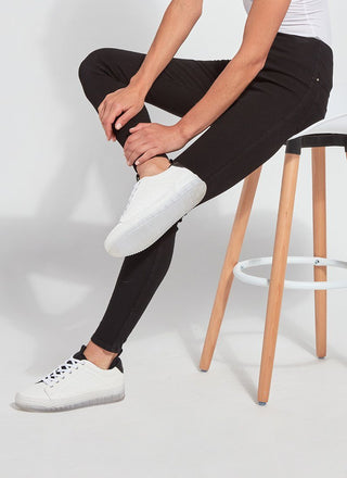 color=Black, Seated side view of black,  toothpick denim jean leggings with patented concealed waistband, seen from waist down