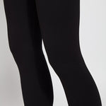 color=Black, Detail view of black ponte laura legging with patented concealed waistband, seen from thighs to calves 