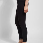 color=Black, side view, leggings with one-piece construction, ankle slits and wide hem, featuring a slimming concealed comfort waistband