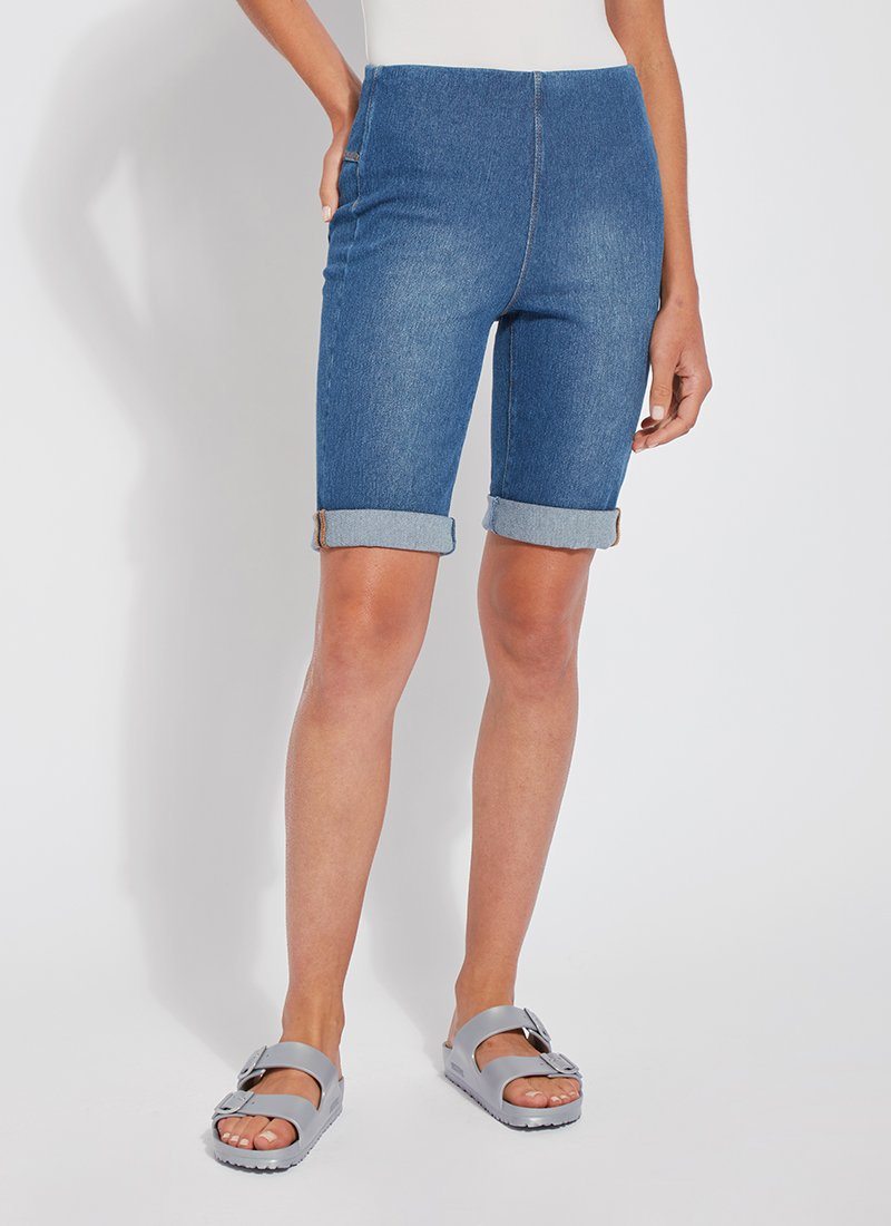color=Mid Wash, front view, women's denim jean short, smoothing comfort waistband, body hugging in hips and looser across thigh