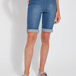 color=Mid Wash, front view, women's denim jean short, smoothing comfort waistband, body hugging in hips and looser across thigh