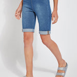color=Mid Wash, front angle, women's denim jean short, smoothing comfort waistband, body hugging in hips and looser across thigh