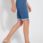 color=Mid Wash, side view, women's denim jean short, smoothing comfort waistband, body hugging in hips and looser across thigh