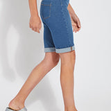 color=Mid Wash, side view, women's denim jean short, smoothing comfort waistband, body hugging in hips and looser across thigh