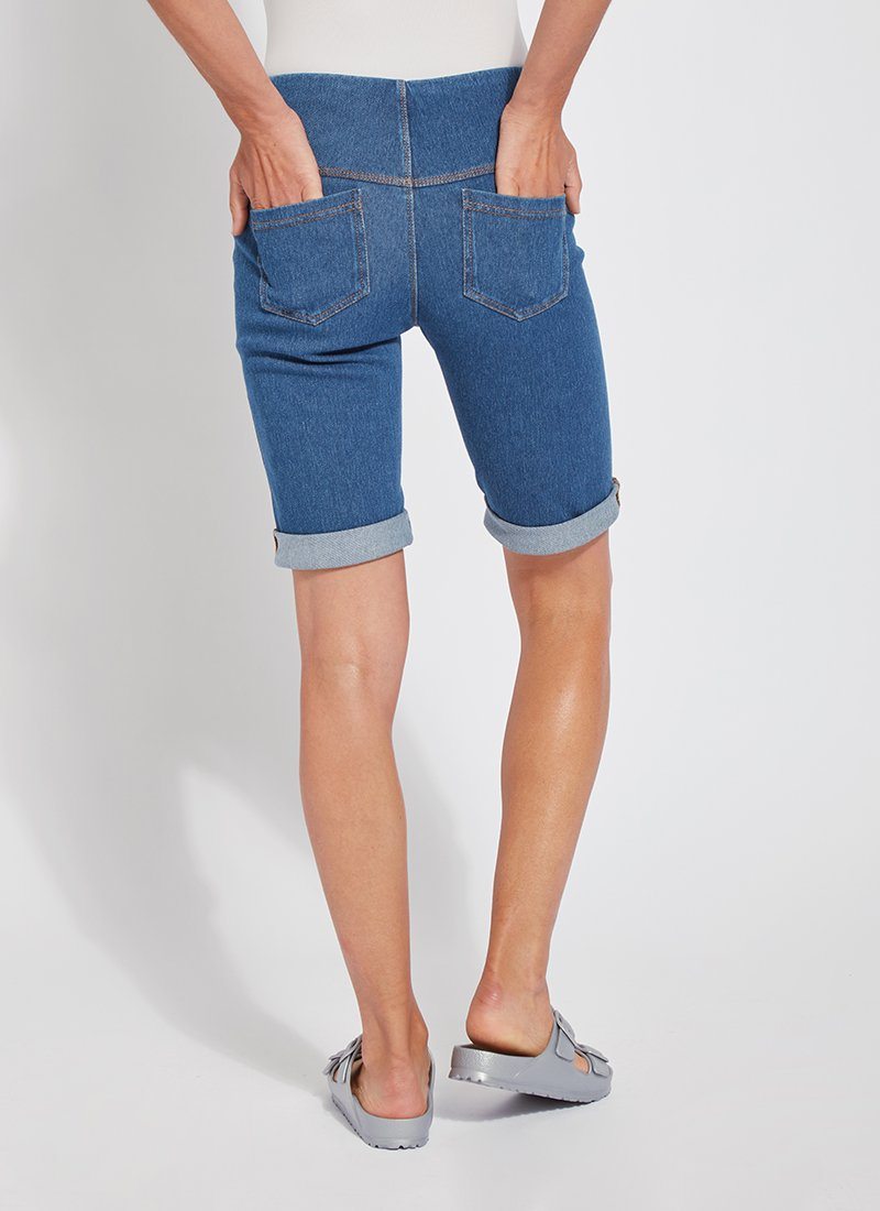 color=Mid Wash, back view, women's denim jean short, smoothing comfort waistband, body hugging in hips and looser across thigh