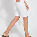 color=White, side view, women's denim jean short, smoothing comfort waistband, body hugging in hips and looser across thigh
