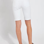 color=White, back view, women's denim jean short, smoothing comfort waistband, body hugging in hips and looser across thigh