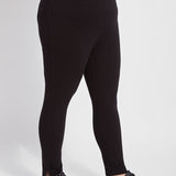 color=Black, side view, plus size denim skinny jean leggings with concealed smoothing waistband for flattering fit
