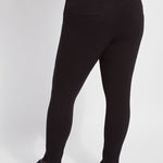 color=Black, back view, plus size denim skinny jean leggings with concealed smoothing waistband for flattering fit