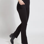 color=Black, Angled side view of black denim straight leg jean leggings with patented concealing waistband