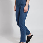 color=Mid Wash, Angled side view mid wash blue denim straight leg jean leggings with patented concealing waistband