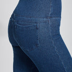 color=Mid Wash, Detailed angled back view of mid wash blue denim straight leg jean leggings with patented concealing waistband